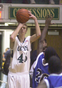 Celina's Aaron Braun, left, tries a three-pointer during Monday's game against Toledo Woodward. Braun had nine points in Celina's 51-38 win.<br>dailystandard.com