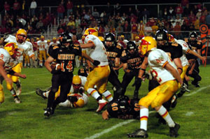 Minster's Michael McVety, with ball, looks for running room in the middle of the New Bremen defense on Friday night night. Minster broke a 7-7 tie with a touchdown late in the fourth quarter to put the Wildcats on top for good, 14-7.<br></br>dailystandard.com
