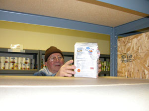 Clyde McCune, a volunteer at CALL Food Pantry in Celina, places a lone bag of flour on the shelf inside the Main Street office. Supplies are dwindling locally due to a large amount of government aid going to hurricane victims and an increase in the number of people eligible for assistance in Ohio.<br></br>dailystandard.com