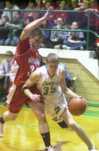 New Bremen's Scott Brackman, with ball, splits Minster's Max Phlipot, left, and Jimmy Stechschulte, right, during their game on Friday night at Cardinal Gymnasium. Brackman scored 17 points to help the Cardinals to their first-ever outright Midwest Athletic Conference title with a 59-41 victory over rival Minster.<br></br>dailystandard.com